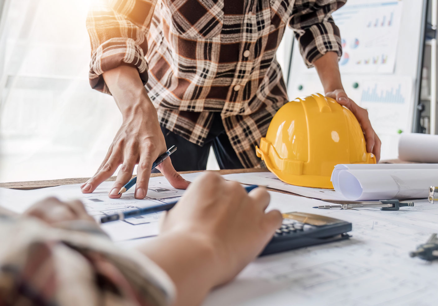 engineer people meeting working and pointing at a drawings in office for discussing. Engineering tools and construction concept...